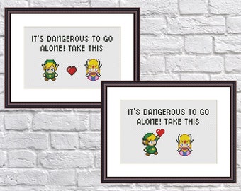 May include: Two framed cross-stitch patterns featuring the characters Link and Princess Zelda from the Legend of Zelda video game series. The text reads "It's dangerous to go alone! Take this".