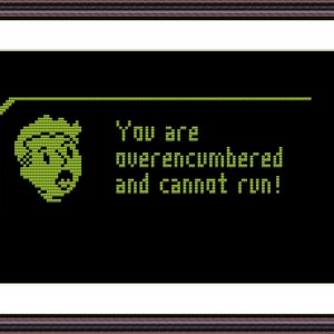 May include: A green pixelated message on a black background reads "You are overencumbered and cannot run!" with a green pixelated cartoon character to the left of the text.