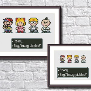 May include: Cross-stitch pattern featuring four pixelated characters from the video game Earthbound. The characters are Ness, Paula, Jeff, and Poo. The pattern includes the text "Ready... Say, "fuzzy pickles!" "