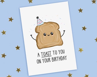 May include: A white card with a cartoon illustration of a slice of toast wearing a party hat and confetti. The text on the card reads "A toast to you on your birthday."