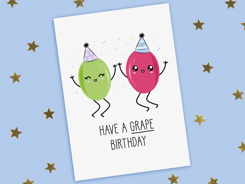 A funny birthday card with a hand drawn image of grapes, one red wearing a blue party hat with pale blue stripes and the other green wearing a blue party hat with pink spots. They are throwing confetti. The card caption is: Have A Grape Birthday.