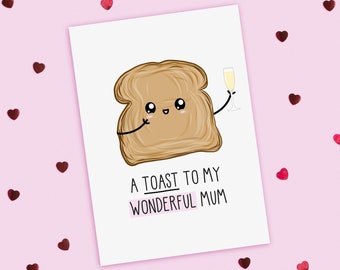 May include: A white card with a cartoon illustration of a slice of toast holding a glass of champagne. The toast has a happy face and the text "A toast to my wonderful mum" is printed below the illustration.