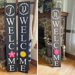 May include: Three wooden welcome signs. Two are black with white lettering, a floral accent, and the letters "F" and "D" at the top. The third is brown with light blue lettering, a tulip accent, and the letter "H" at the top.