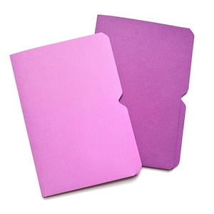 May include: Two textured paper file folders in shades of purple and pink. The folders have a rectangular shape with a notched edge on one side. The folders are set against a white background.