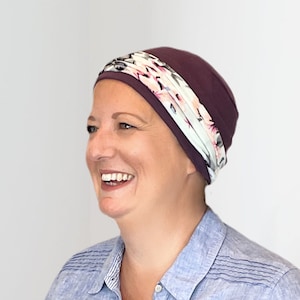 Comfortable hats for cancer patients with detachable headband. Versatile & flattering easy to wear chemo hat in a variety of colours Plum & Aqua HB