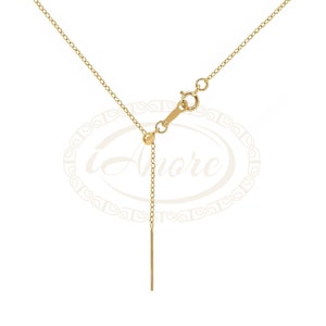 May include: A gold chain necklace with a small ball at the end of the chain. The chain has a lobster clasp and an adjustable length.
