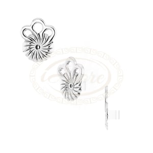 May include: A pair of silver earrings with a floral design. The earrings are made of metal and have a delicate, intricate design.