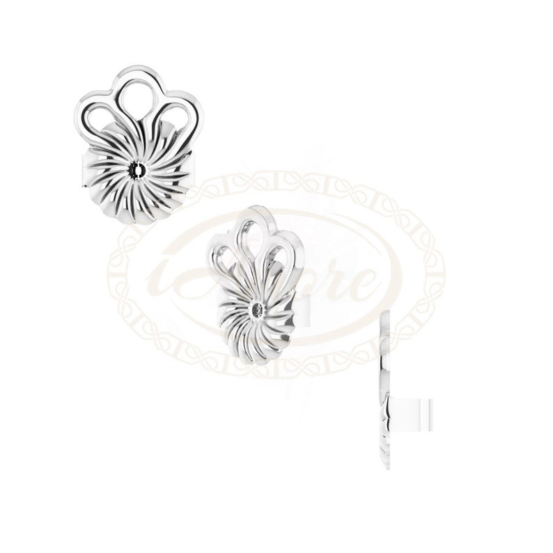 May include: A pair of silver earrings with a floral design. The earrings are made of metal and have a delicate, intricate design.