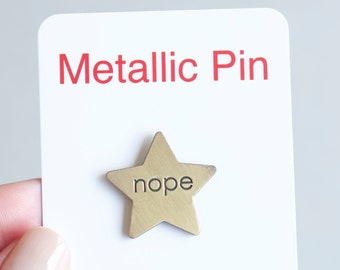 Nope metallic gold star pin