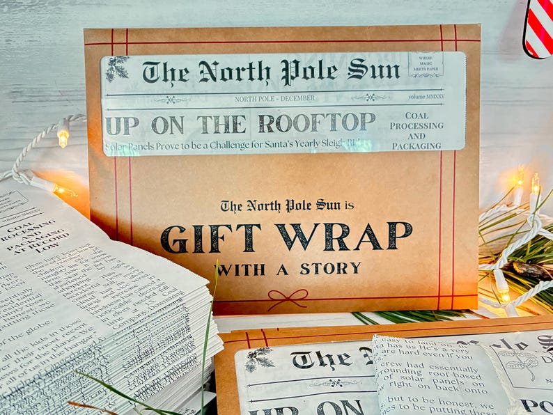 May include: A tan paper gift wrap sheet featuring a newspaper-style header titled The North Pole Sun, with the headline Up On The Rooftop and the text Gift Wrap With A Story. The design includes red line borders and a small red bow illustration.