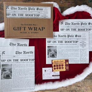 May include: A set of gift wrap sheets featuring The North Pole Sun newspaper print with the headline Up On The Rooftop, a brown envelope, a small white card with coffee cup icons, and a brown scratch-off member card with circular gold foil spots.