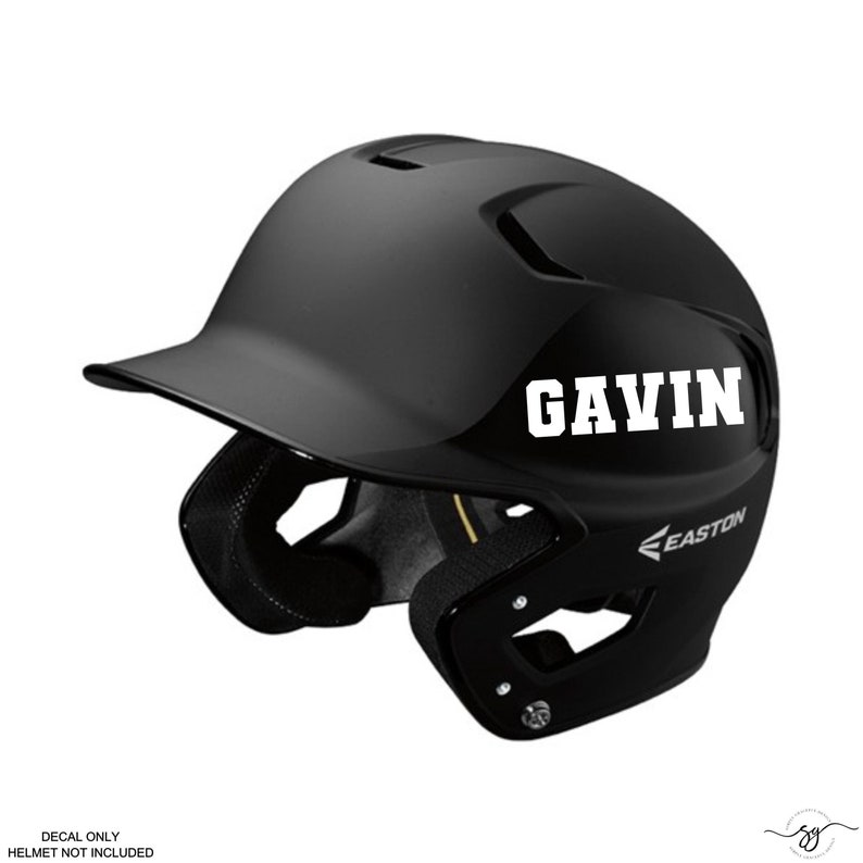 May include: Black baseball helmet with a white decal that says "GAVIN" on the side. The helmet is made by Easton.