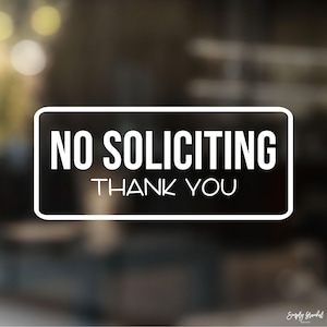 May include: White rectangular sign with black text that reads "NO SOLICITING THANK YOU".