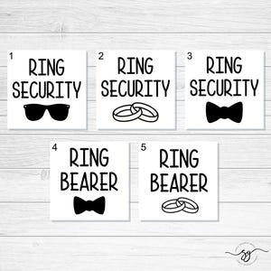 May include: Five printable wedding party signs with black text on a white background. The signs read "Ring Security" with sunglasses, "Ring Security" with wedding rings, "Ring Security" with a bow tie, "Ring Bearer" with a bow tie, and "Ring Bearer" with wedding rings.