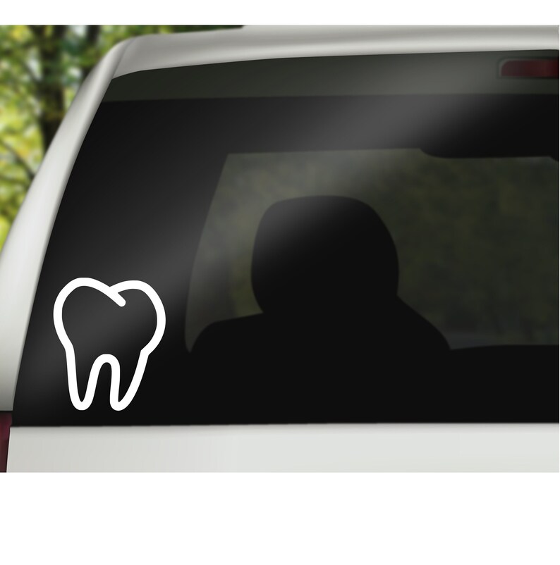 May include: A white outline of a tooth on a black car window.