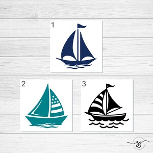 May include: Three sailboat designs, each with a different color scheme. The first sailboat is blue, the second is teal with a red, white, and blue striped sail, and the third is black with a red, white, and blue striped sail.