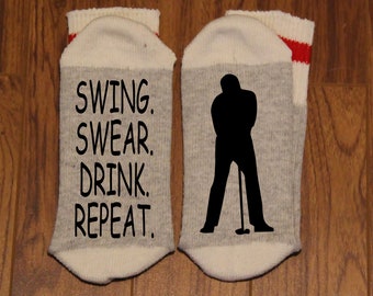 Swing. Swear. Drink. Repeat. ... with a Silhouette of a Golfer (Word Socks - Funny Socks - Novelty Socks)