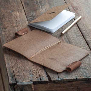 Handmade leather journal. Leather notebook cover. Leather sketchbook cover with a pen holder. Vegetable tanned leather from Italy. Handmade in Finland. open empty.