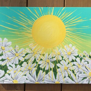May include: A painting of a bright yellow sun with rays shining down on a field of white daisies. The background is a gradient of turquoise, green, and yellow.