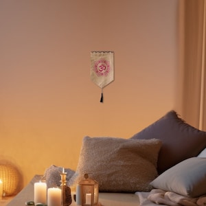 May include: A wooden platform bed with a beige linen comforter and several pillows. The bed is decorated with candles and a small lantern. There is a plant in a pot on the left side of the image.