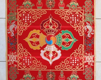 May include: Red square textile with gold trim and intricate embroidery. The central design features a multi-colored emblem with a blue and orange center, surrounded by ornate patterns and symbols. The corners and edges are adorned with additional decorative elements.