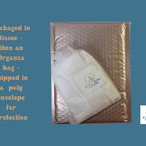 May include: A gold bubble mailer with a white organza bag inside. The bag has a small white tag with the text "A Fur Baby Favorite".