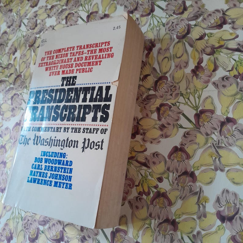 May include: A hardcover book titled "The Presidential Transcripts" with text from The Washington Post. The cover features the title in large, bold letters and includes the names of Bob Woodward and Carl Bernstein. The book is tan and white.