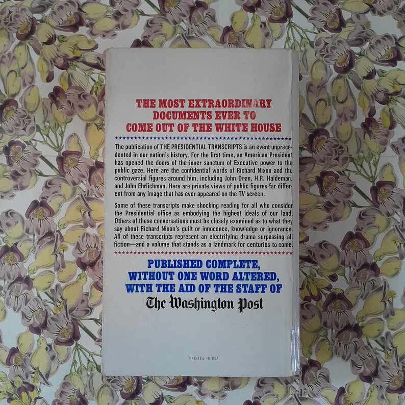May include: A book cover with red and blue text on a white background, set against a floral pattern. The title is "THE MOST EXTRAORDINARY DOCUMENTS EVER TO COME OUT OF THE WHITE HOUSE." The text details The Presidential Transcripts.