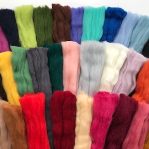 May include: A collection of 30 different colors of wool roving, arranged in a fan shape. The wool is soft and fluffy, and the colors are vibrant and varied.