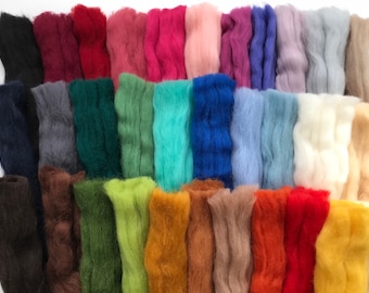 May include: A collection of 24 different colored wool roving fibers. The colors include black, dark red, burgundy, red, pink, light pink, purple, blue, light blue, teal, green, dark green, lime green, yellow, orange, brown, tan, beige, light brown, peach, red, yellow, and white.