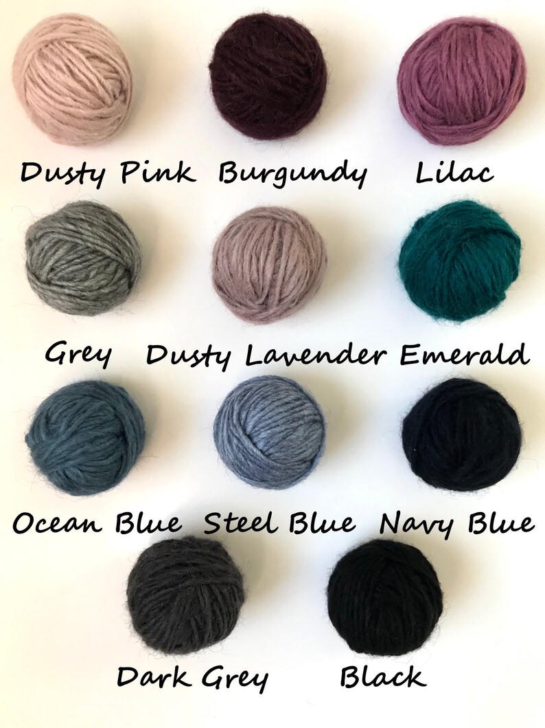 May include: Balls of yarn in various colors, including dusty pink, burgundy, lilac, grey, dusty lavender, emerald, ocean blue, steel blue, navy blue, dark grey, and black.
