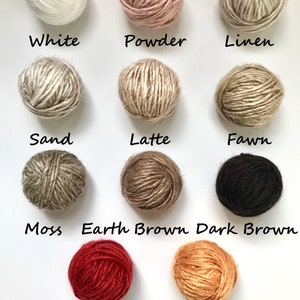 May include: Balls of yarn in various colors, including white, powder, linen, sand, latte, fawn, moss, earth brown, dark brown, persimmon red, and yellow gold.