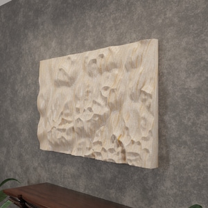 May include: A beige, textured, wooden wall art piece with a raised, abstract design. The art is mounted on a grey wall above a dark wood mantel.