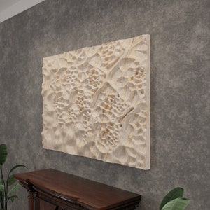 May include: A beige wall art piece with a textured, organic pattern. The piece is made of a light-coloured material and has a raised, three-dimensional design.