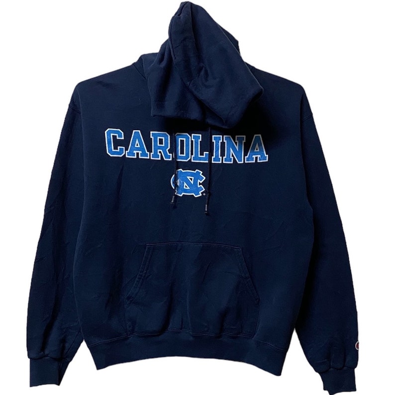 May include: A navy blue hooded sweatshirt with the word "CAROLINA" in white outlined in blue lettering and a blue and white "NC" logo on the front.