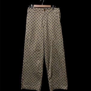 May include: Beige wide-leg pants with a black polka dot pattern.