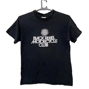 May include: Black t-shirt with a white graphic that says "Black Rebel Motorcycle Club" with a circle design above the text.