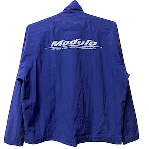 May include: A blue windbreaker jacket with the text "Modulo Honda Custom Performance" in silver lettering on the back.