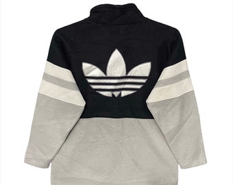 May include: A black and grey fleece zip-up jacket with a large white Adidas logo on the back.