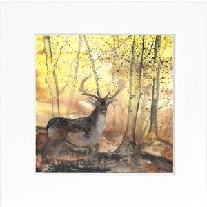 May include: A watercolour painting of a deer standing in a woodland setting. The deer has large antlers and is looking directly at the viewer. The background is a soft yellow and brown, with trees and foliage.