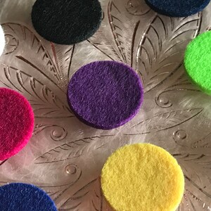 Peut inclure: Assortiment de cercles en feutre de diff&eacute;rentes couleurs, notamment noir, blanc, violet, rose, vert, jaune et bleu. Les cercles sont dispos&eacute;s sur une surface en verre d&eacute;corative.