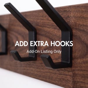 May include: Close-up of a wooden wall-mounted hook rack with three black metal hooks. The wood has a rich, dark brown grain. Text on the image reads "ADD EXTRA HOOKS" and "Add-On Listing Only".