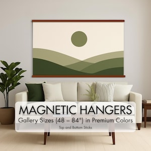 May include: A large wall art print with a minimalist landscape design, featuring a green sun and rolling hills in shades of green. The print is displayed with magnetic hangers, with text that reads "MAGNETIC HANGERS" and "Gallery Sizes (48 - 84") in Premium Colors".