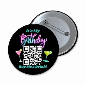 May include: A black button with a QR code, two cocktail glasses, and the text "It's My Birthday Buy Me a Drink!" in neon pink and blue lettering.