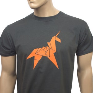 May include: A dark grey t-shirt with an orange origami unicorn design.