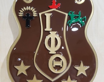 May include: A brown shield with gold trim and five gold stars. The shield features a gold Greek letter design "IΦΘ" and various symbols including a cross, a dove, a candle, and a green horse.