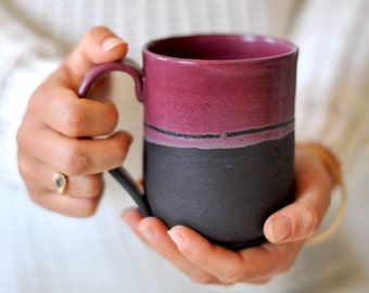 Raspberry red wine and black ceramic mug