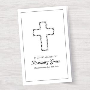 May include: A white card with a black cross design and the text "In loving memory of Rosemary Green May 20th 1943 - July 30th 2016".