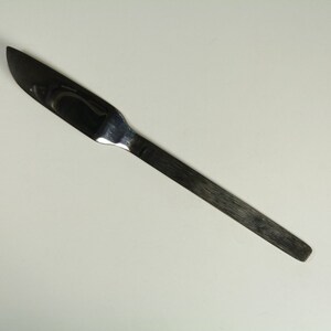 May include: A silver surgical scalpel with a sharp blade and a long, thin handle.