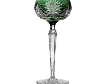 May include: A tall, clear glass with a green bowl and intricate cut glass design. The stem is long and slender, with a decorative pattern. The base is wide and flared, also with a cut glass design.